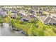 An elevated view showcases the home's backyard with lake frontage, complemented by mature trees at 5883 Great Salt Ct, Lakeland, FL 33805