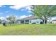 The backyard features a well-maintained lawn, a cozy patio, and a black fence, creating a perfect outdoor oasis at 5883 Great Salt Ct, Lakeland, FL 33805