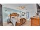 Relaxing bedroom boasts a decorative wood headboard, ceiling fan and stylish lamps for comfort at 5883 Great Salt Ct, Lakeland, FL 33805