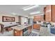 Kitchen with granite counters, stainless appliances, wood cabinets, island, and a view of the dining area at 5883 Great Salt Ct, Lakeland, FL 33805