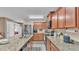 Kitchen with granite counters, stainless appliances, wood cabinets, island with seating, and a breakfast nook at 5883 Great Salt Ct, Lakeland, FL 33805