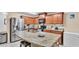Kitchen featuring granite countertops, stainless steel appliances, wood cabinets, and an island with seating at 5883 Great Salt Ct, Lakeland, FL 33805