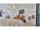 Bright main bedroom featuring a decorative fireplace, modern flooring, and TV at 5883 Great Salt Ct, Lakeland, FL 33805