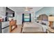 Cozy main bedroom featuring a decorative fireplace, ceiling fan, and serene water views at 5883 Great Salt Ct, Lakeland, FL 33805