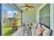 Outdoor patio with cushioned seating, modern ceiling fan, area rug and exterior views at 5883 Great Salt Ct, Lakeland, FL 33805