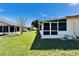 Lush green backyard with a screened-in patio, perfect for outdoor relaxation and entertainment at 6059 Condor Dr, Lakeland, FL 33809