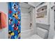 Bright bathroom with Mickey Mouse shower curtain and white built in shelves at 6059 Condor Dr, Lakeland, FL 33809