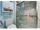 A modern bathroom features sleek fixtures and a fully tiled, accessible walk-in shower with grab bars at 6059 Condor Dr, Lakeland, FL 33809
