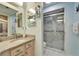 A bright bathroom features a granite vanity and enclosed shower with gray marble design at 6059 Condor Dr, Lakeland, FL 33809