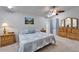 Bright bedroom featuring a ceiling fan, natural light, and light wood furniture set against neutral carpeting at 6059 Condor Dr, Lakeland, FL 33809