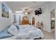 Bedroom with ceiling fan, TV, and a dresser, complemented by a quaint side table at 6059 Condor Dr, Lakeland, FL 33809
