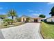 Beautiful residence with a manicured lawn and a gorgeous brick driveway, presenting an inviting curb appeal at 6059 Condor Dr, Lakeland, FL 33809