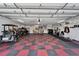 Spacious garage featuring a golf cart and checkered floor design at 6059 Condor Dr, Lakeland, FL 33809