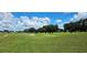 Picturesque view of the golf course featuring lush fairways and mature trees at 6059 Condor Dr, Lakeland, FL 33809