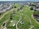 Scenic aerial view of a lush golf course with manicured greens and surrounding homes at 6059 Condor Dr, Lakeland, FL 33809