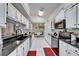 Spacious kitchen with sleek countertops, white cabinetry, and modern appliances for a chef's delight at 6059 Condor Dr, Lakeland, FL 33809