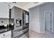 Modern stainless steel refrigerator in a kitchen with white cabinets and gray walls at 6059 Condor Dr, Lakeland, FL 33809