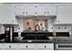 Kitchen sink with black countertops and white cabinets with a pass-through window to another room at 6059 Condor Dr, Lakeland, FL 33809