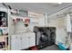Efficient laundry room with modern washer and dryer, sink, and ample storage space with shelving at 6059 Condor Dr, Lakeland, FL 33809