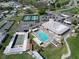 Aerial shot of a community pool, tennis, shuffleboard, parking, and clubhouse at 6059 Condor Dr, Lakeland, FL 33809