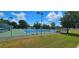 Well-maintained tennis court with green fencing and ample lighting at 6059 Condor Dr, Lakeland, FL 33809