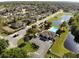 Community aerial showcasing a pool and recreation center, parking, pond, and well-maintained landscaping at 6472 Evergreen Park Dr, Lakeland, FL 33813