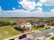 An aerial view showcases a well-maintained property with lush landscaping, close to a natural wetland at 661 Black Eagle Dr, Groveland, FL 34736