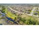 An aerial shot reveals a residential area bordering a wetland, illustrating the integration of homes and natural landscapes at 661 Black Eagle Dr, Groveland, FL 34736