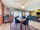 Dining area with table, chairs, chandelier, and sliding glass doors to the outdoor patio at 661 Black Eagle Dr, Groveland, FL 34736