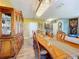 Bright dining room featuring a long wooden table, seating for six, and a decorative chandelier at 661 Black Eagle Dr, Groveland, FL 34736