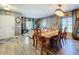 Open-concept dining area with stylish table, chairs, and chandelier, perfect for entertaining guests at 661 Black Eagle Dr, Groveland, FL 34736