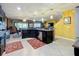 This kitchen boasts stainless steel appliances, dark cabinets, and pendant lights over the bar at 661 Black Eagle Dr, Groveland, FL 34736