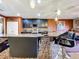 Kitchen with a mosaic bar, granite countertop, stainless steel appliances and dark wood cabinetry at 661 Black Eagle Dr, Groveland, FL 34736