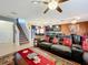 Inviting living room seamlessly blends into a modern kitchen with a breakfast bar, stairs leading upstairs at 661 Black Eagle Dr, Groveland, FL 34736