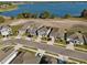 Neighborhood aerial view of modern houses, community streets, and lakeside proximity at 728 Trotters Dr, Eagle Lake, FL 33839