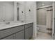 Modern bathroom featuring double vanity sinks, stylish fixtures, and tiled shower with curtain at 728 Trotters Dr, Eagle Lake, FL 33839