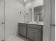 Bathroom featuring a dual sink vanity, framed mirrors, and modern fixtures at 728 Trotters Dr, Eagle Lake, FL 33839
