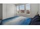 Serene bedroom with blue bedding, abundant natural light from windows, and spacious closet at 728 Trotters Dr, Eagle Lake, FL 33839