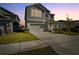 Charming two-story home featuring neutral gray siding, manicured lawn and an attached two-car garage at 728 Trotters Dr, Eagle Lake, FL 33839