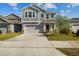 Charming two-story home featuring neutral gray siding, manicured lawn and an attached two-car garage at 728 Trotters Dr, Eagle Lake, FL 33839