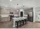 Modern kitchen featuring a central island with bar seating, stainless steel appliances and stylish finishes at 728 Trotters Dr, Eagle Lake, FL 33839