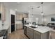 Contemporary kitchen with a central island, stainless steel appliances, and sleek, modern finishes at 728 Trotters Dr, Eagle Lake, FL 33839