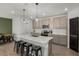 Modern kitchen with a quartz island, stainless appliances, pendant lights, and a pantry at 728 Trotters Dr, Eagle Lake, FL 33839