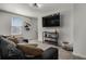 Cozy living room with a wall-mounted TV, plush sofa, and stylish decor at 728 Trotters Dr, Eagle Lake, FL 33839