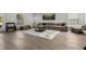 Comfortable living room featuring neutral décor, tile flooring, and abundant natural light at 728 Trotters Dr, Eagle Lake, FL 33839