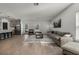 Bright open-concept living room featuring tile flooring, a modern rug and a comfortable sofa set at 728 Trotters Dr, Eagle Lake, FL 33839