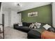 Inviting living room features a comfortable couch and a coordinating green accent wall at 728 Trotters Dr, Eagle Lake, FL 33839