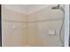 Shower stall with tan tile and decorative border, including rainfall shower head at 7335 Beaumont Dr, Lakeland, FL 33810