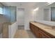 Bathroom featuring double vanity with granite counters, stylish lighting, and a glass-enclosed shower at 7947 Lake James Blvd, Lakeland, FL 33810