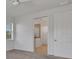 Bedroom featuring neutral carpet and an open doorway leading to a view of a bathroom at 7947 Lake James Blvd, Lakeland, FL 33810